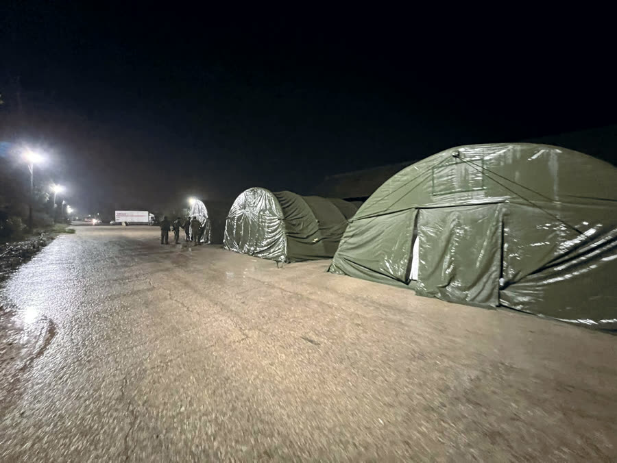 Shelter systems deployed in the field at night
